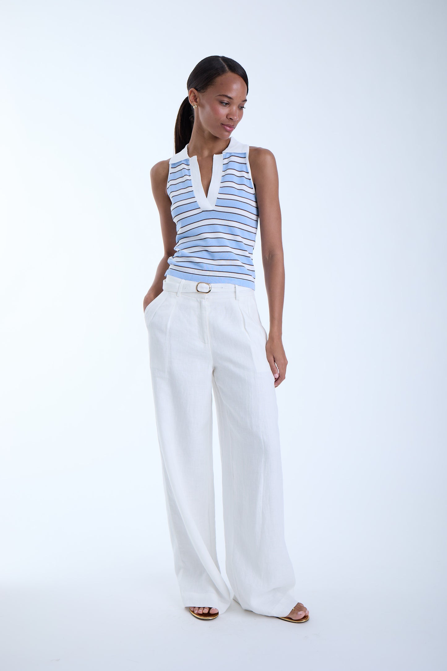 Front view of the Kira Knit Sleeveless Top in blue stripe with a collared V-neckline, sleeveless silhouette, and ribbed knit finish.