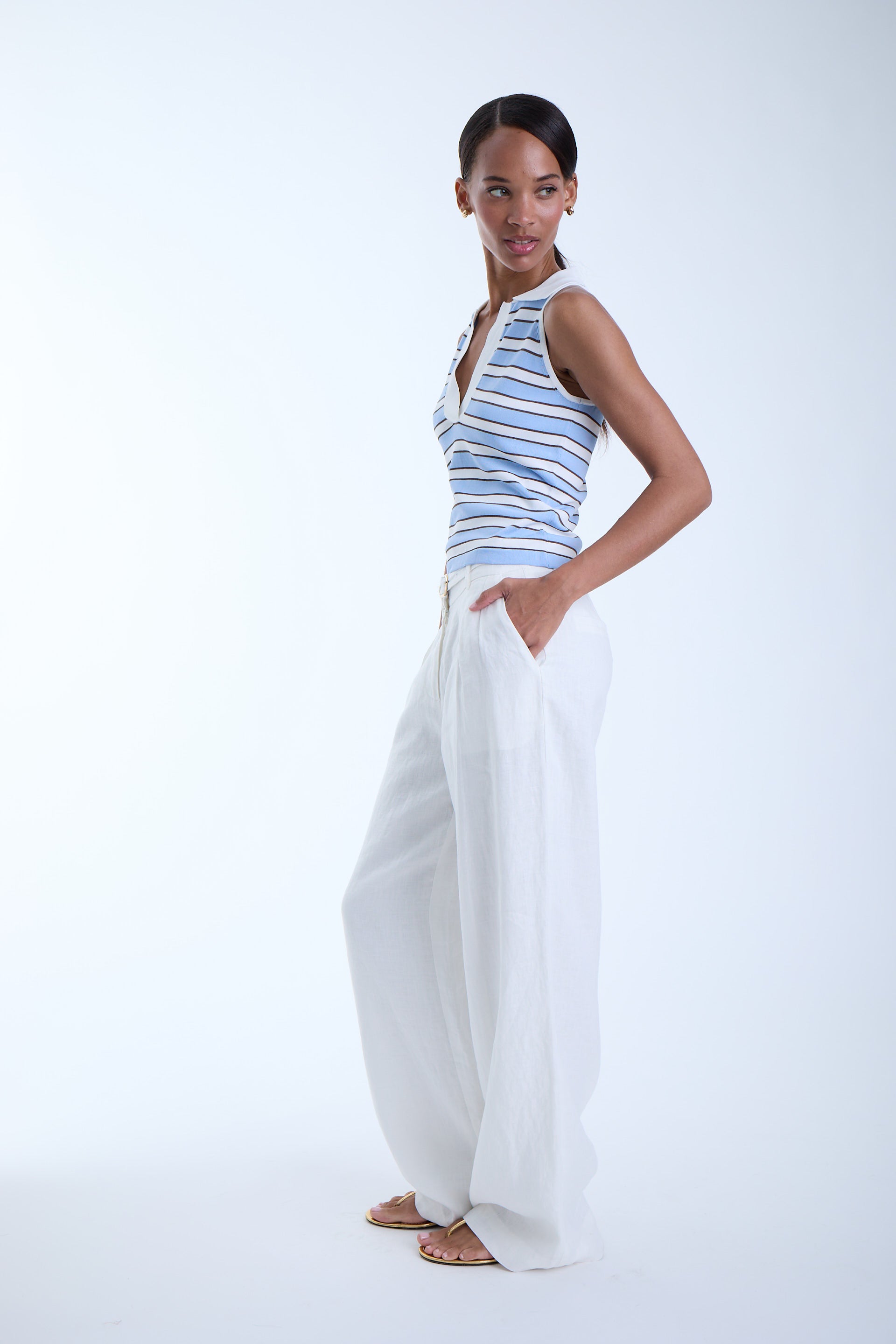 Side view of the Kira Knit Sleeveless Top in blue stripe highlighting the close fit, sleeveless design, and soft stretch knit fabric.