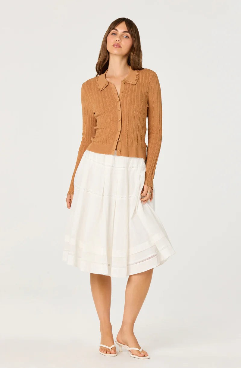 Model styling the Kristen Cardigan in nutmeg brown with a flowing white midi skirt for a soft vintage-inspired look.