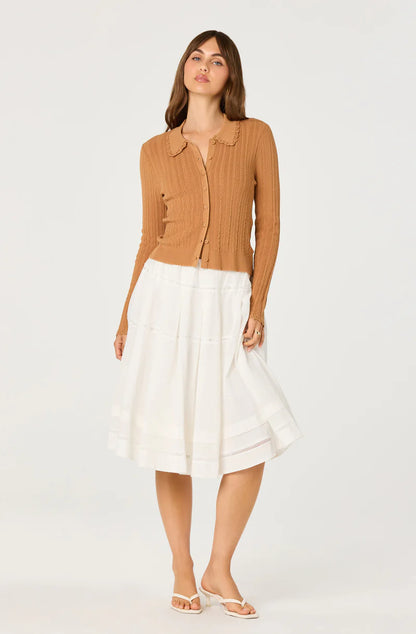 Model styling the Kristen Cardigan in nutmeg brown with a flowing white midi skirt for a soft vintage-inspired look.