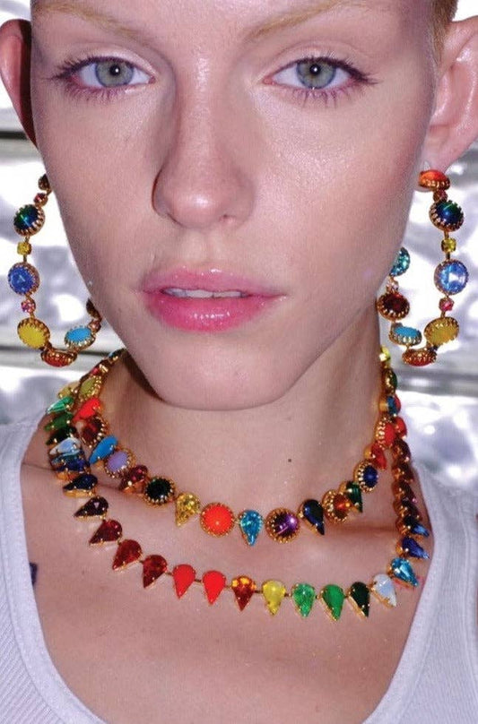 Model wearing the Layering Choker in Kaleidoscope Gold with multicolor vintage glass stones and a layered statement necklace look.