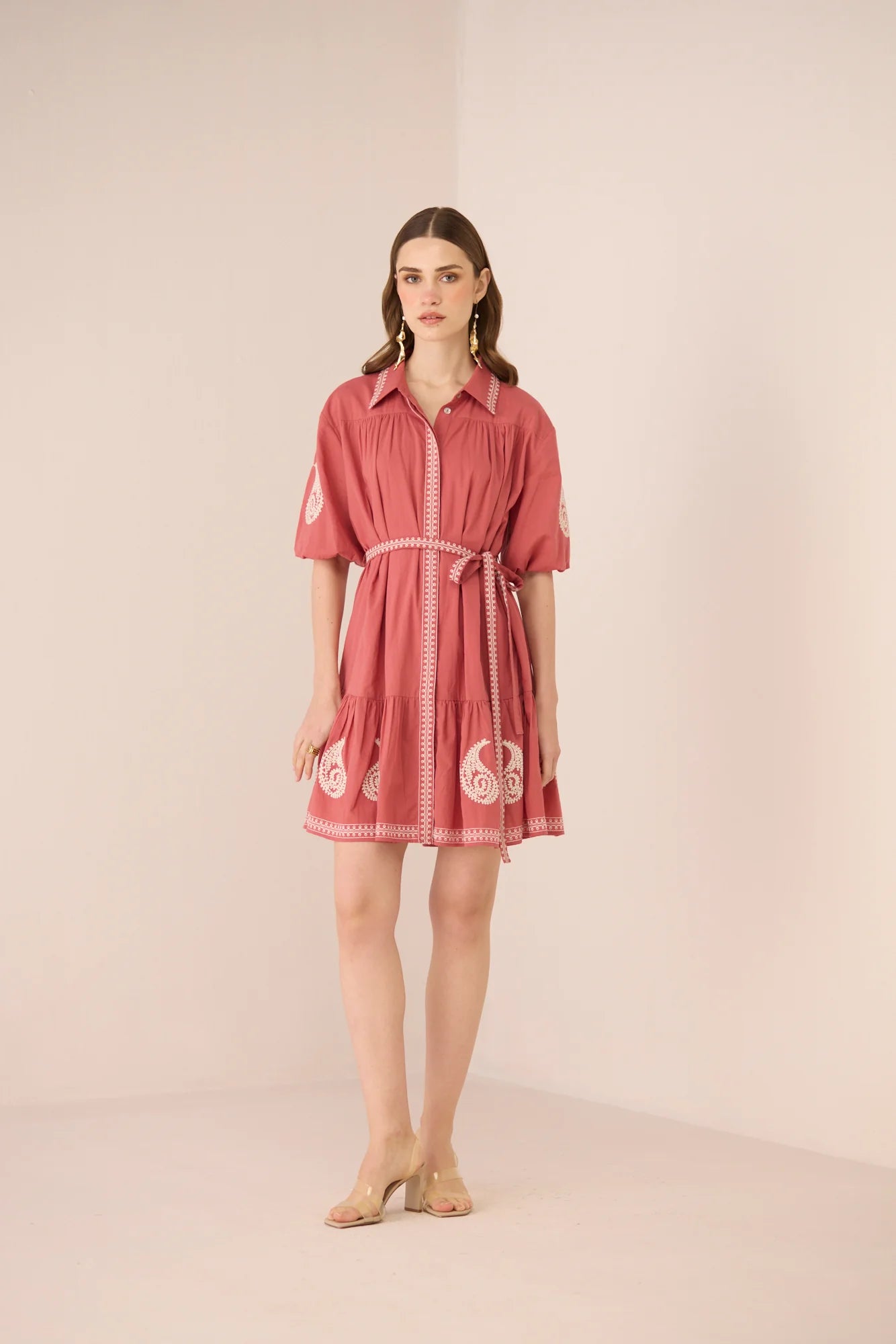 Full-length studio image of the Lizzie Mini Dress with cream paisley embroidery, short gathered sleeves, and matching waist belt.