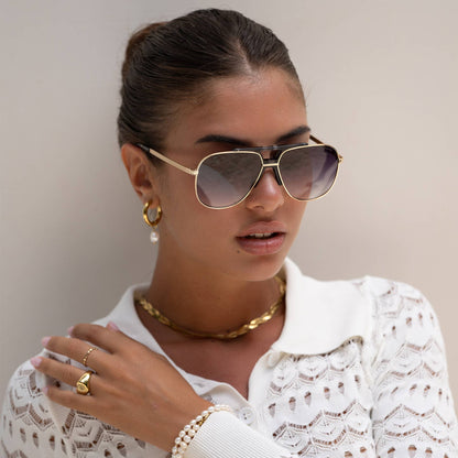 Model wearing Logan acetate aviator unisex sunglasses with a light gold frame and gray lenses.