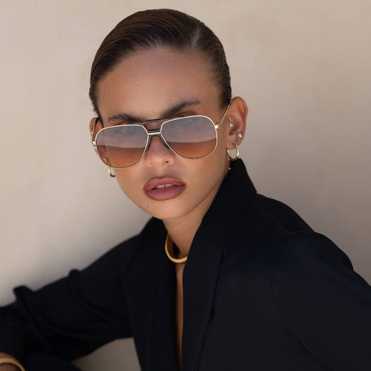 Model wearing Logan Acetate Aviator Unisex Sunglasses with sunrise gradient lenses and polished aviator frames.