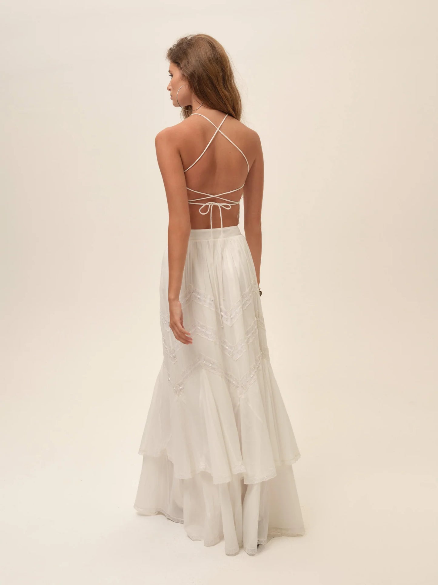 Back view of the Lou Scarf Top in ivory featuring delicate crisscross tie straps, open-back design, and matching embroidered maxi skirt.