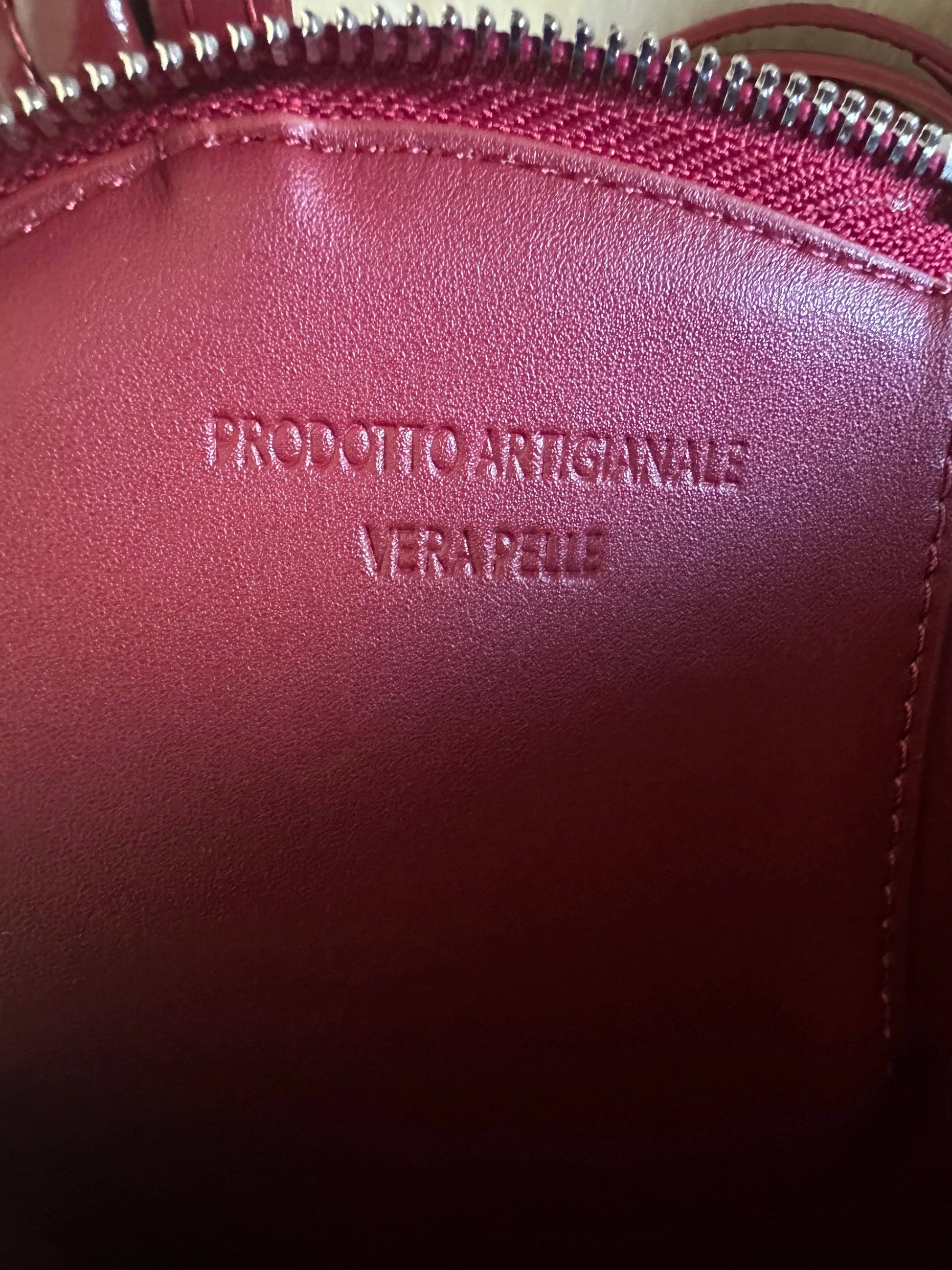 Interior detail of the Love Heart-Shaped Genuine Leather Handbag in Burgundy featuring genuine leather lining and embossed artisanal craftsmanship stamp.
