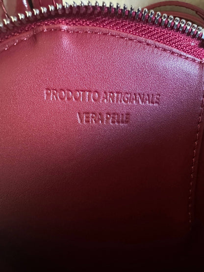 Interior detail of the Love Heart-Shaped Genuine Leather Handbag in Burgundy featuring genuine leather lining and embossed artisanal craftsmanship stamp.