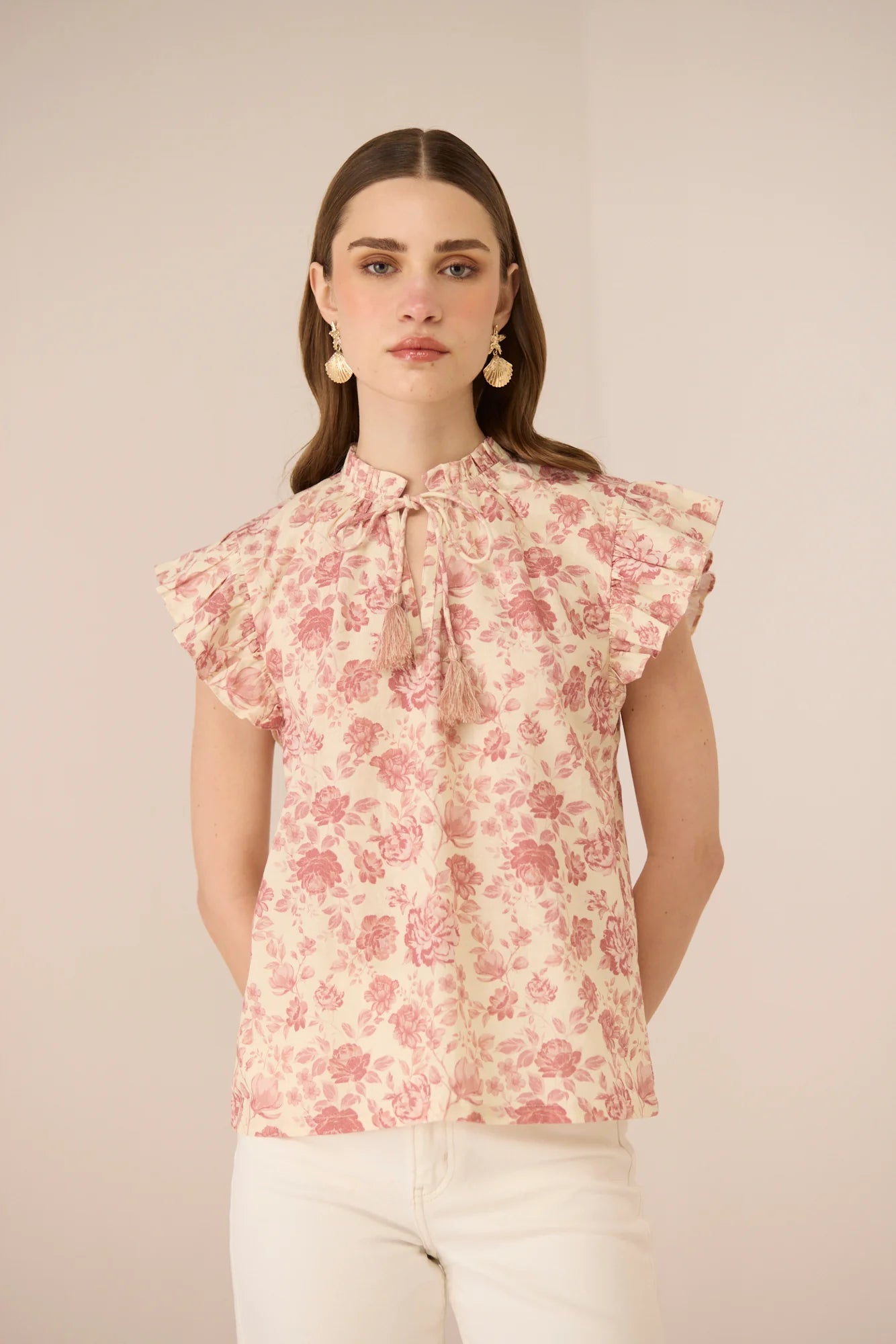 Close front view of the Madison Blouse featuring the gathered neckline, tie detail, and feminine frill sleeves.