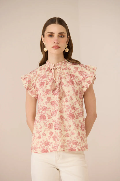 Close front view of the Madison Blouse featuring the gathered neckline, tie detail, and feminine frill sleeves.