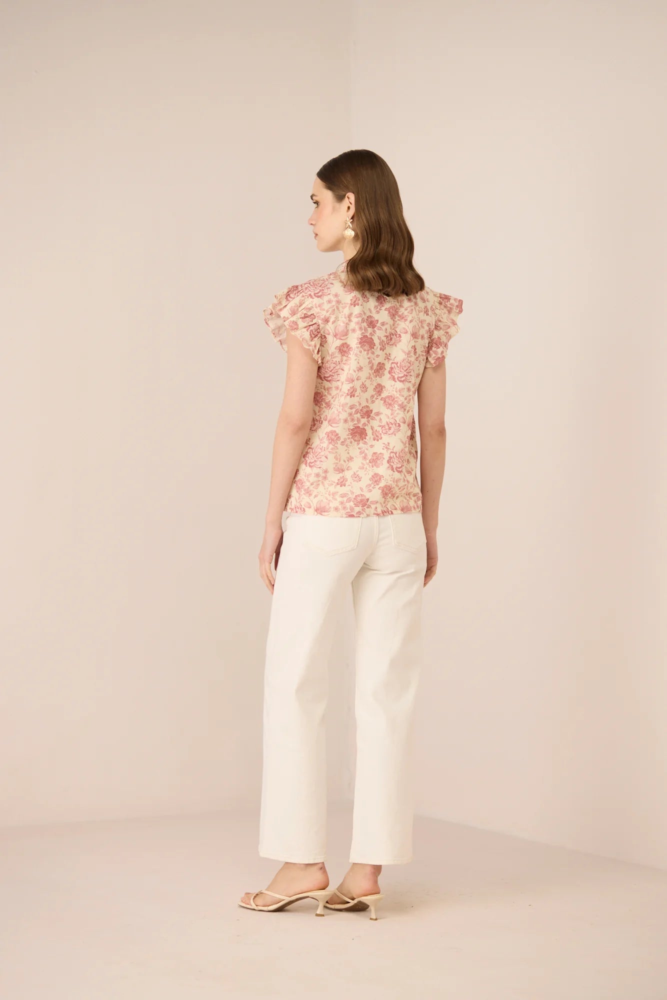 Side view of the Madison Blouse showing the relaxed fit, frill sleeves, and soft floral print.