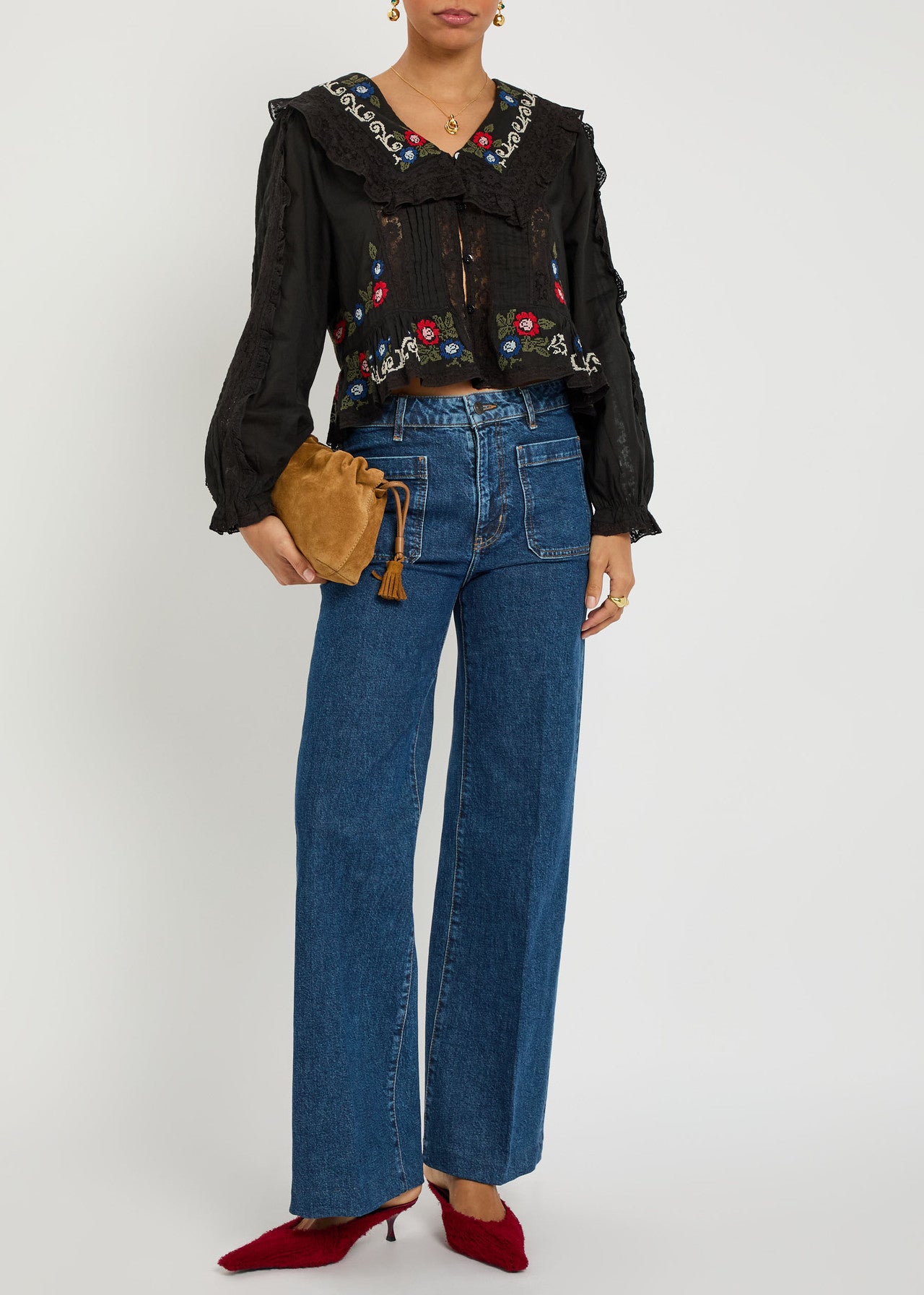Full outfit view of the Maribelle Top styled with wide-leg denim jeans and heels, featuring colorful embroidery and romantic lace details.