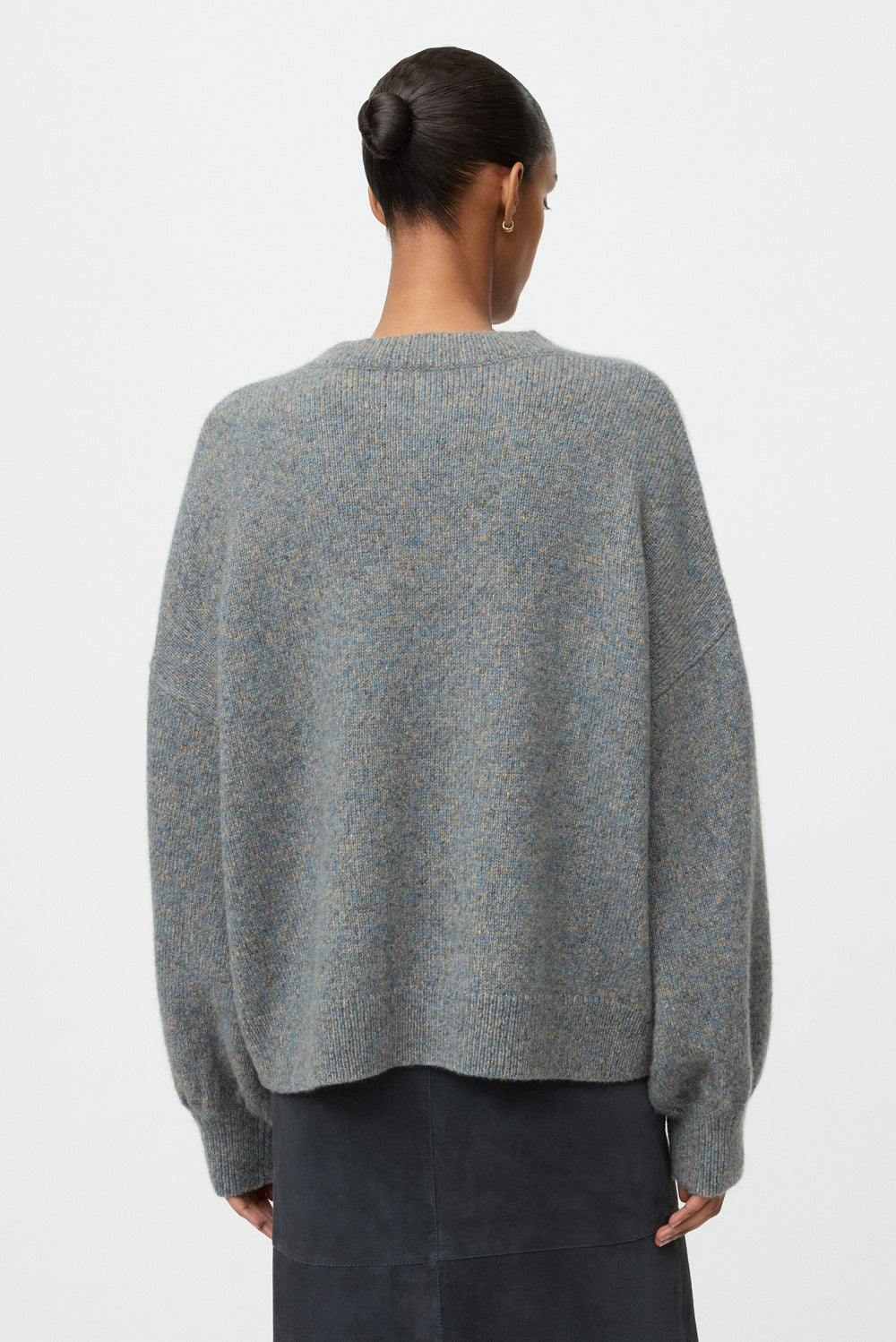 Back view of the blue-grey marled crewneck showing its relaxed fit and dropped shoulders.