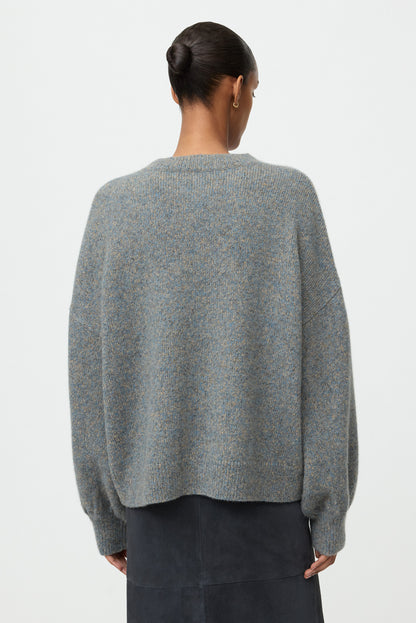 Back view of the blue-grey marled crewneck showing its relaxed fit and dropped shoulders.