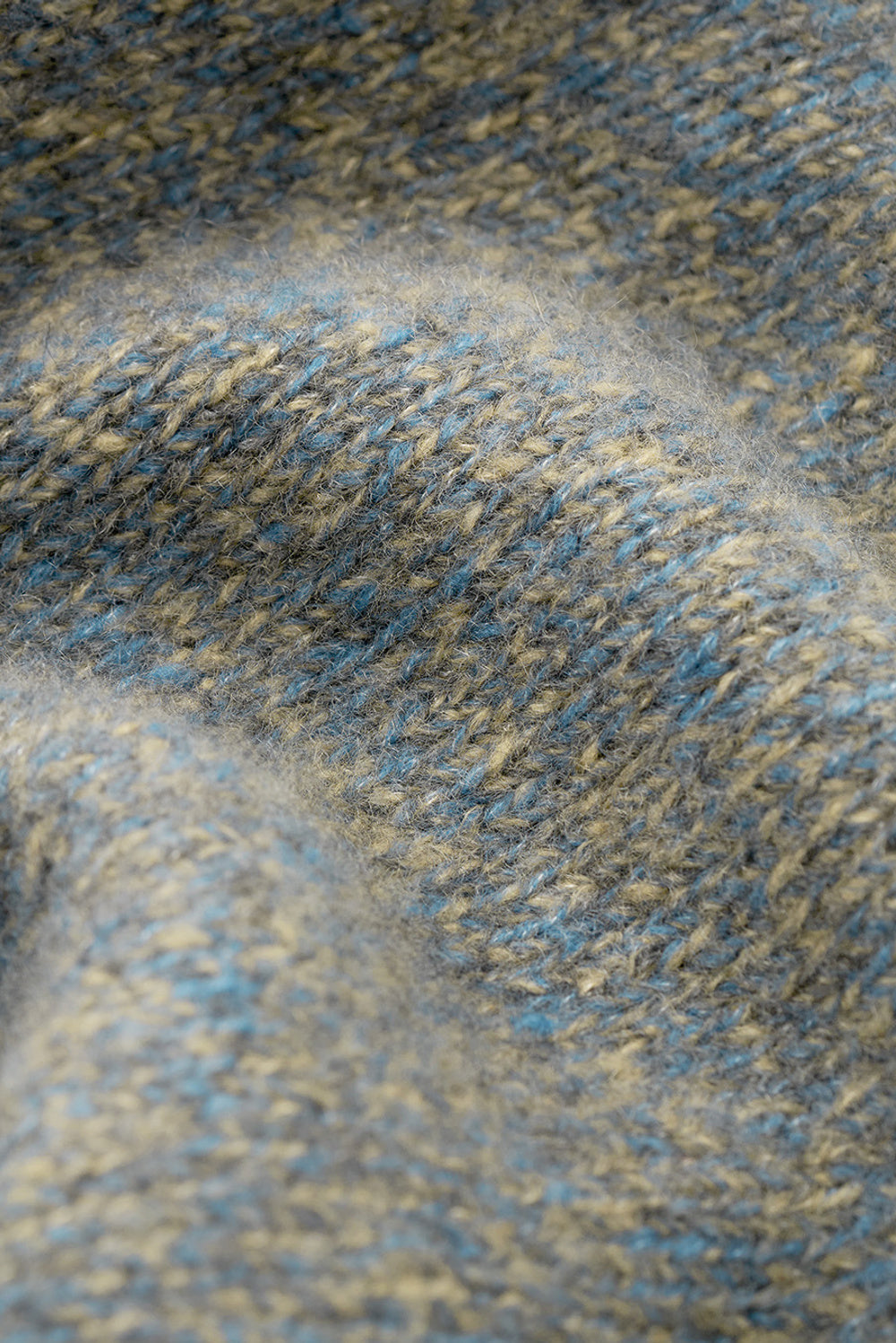 Close-up of the blue-grey marled cashmere and silk knit texture.