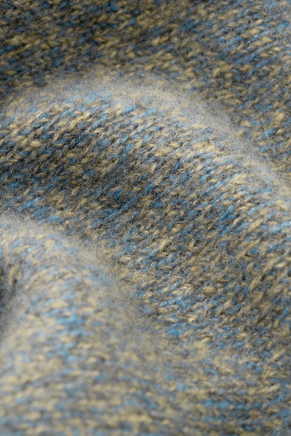 Close-up of the blue-grey marled cashmere and silk knit texture.