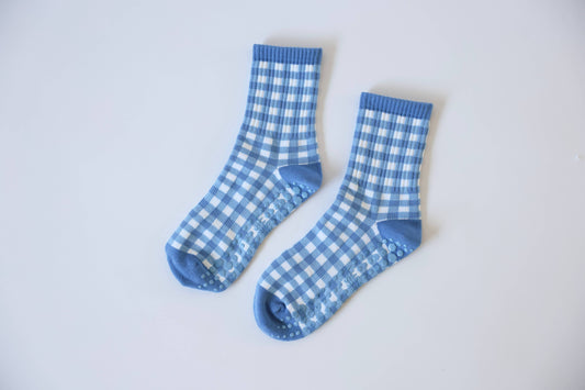 Pair of blue and white gingham Martha's Vineyard grip socks displayed flat, showcasing the checkered pattern and non-slip sole grips.