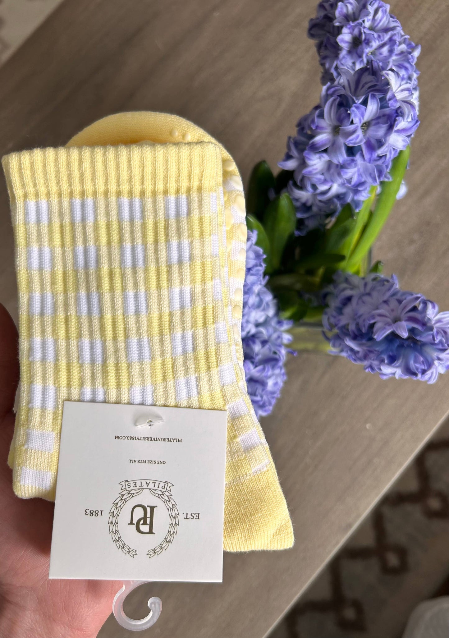 Detailed view of the Martha's Vineyard Yellow grip socks showcasing the pastel yellow and white gingham pattern, ribbed cuff, and soft knit texture.