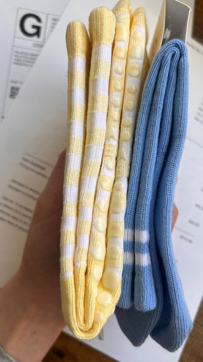Side view of the Martha's Vineyard Yellow grip socks highlighting the crew-length silhouette, gingham knit pattern, and silicone grip placement on the sole.