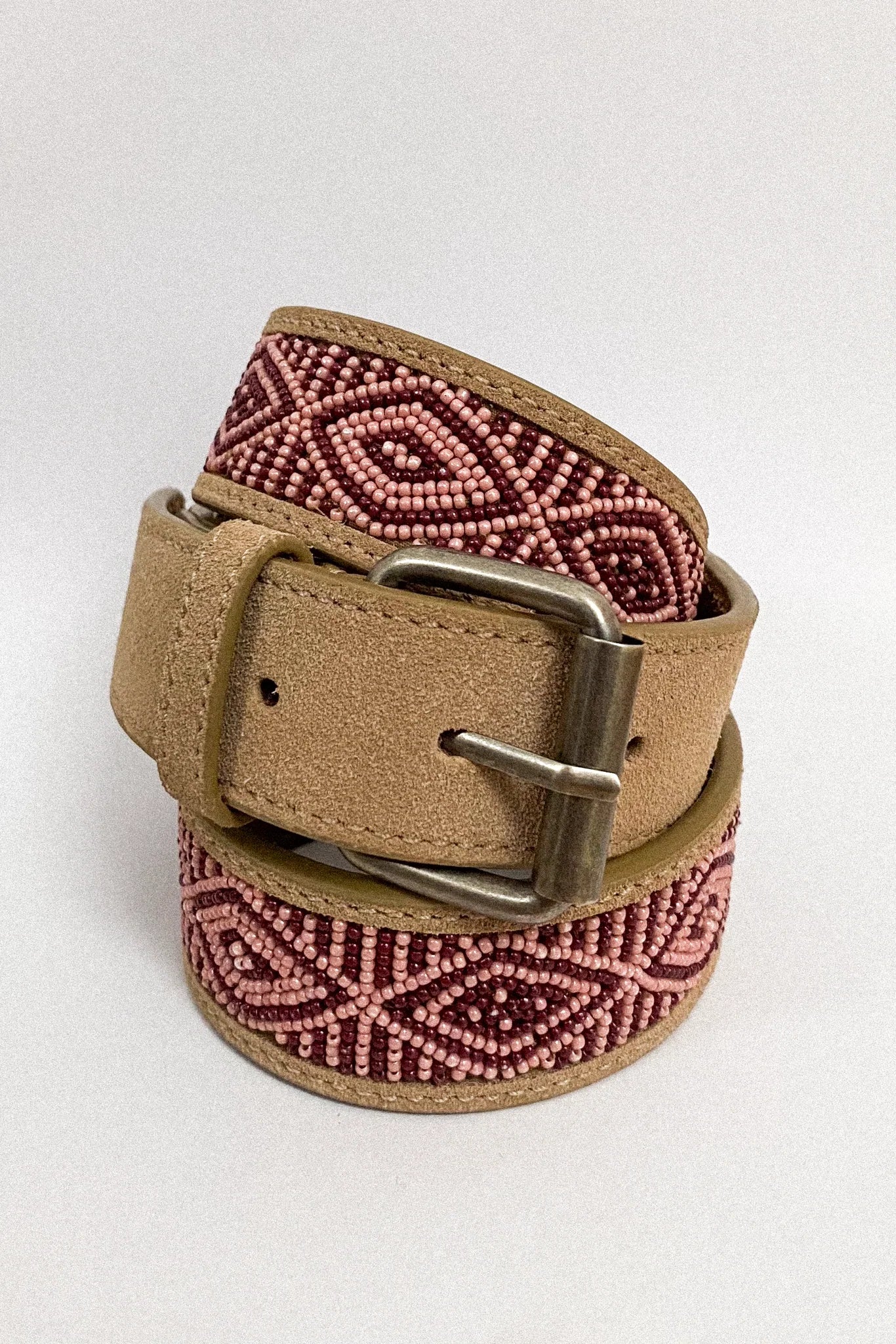 Rolled Masai Kilimanjaro leather belt featuring geometric beadwork and square metal buckle.