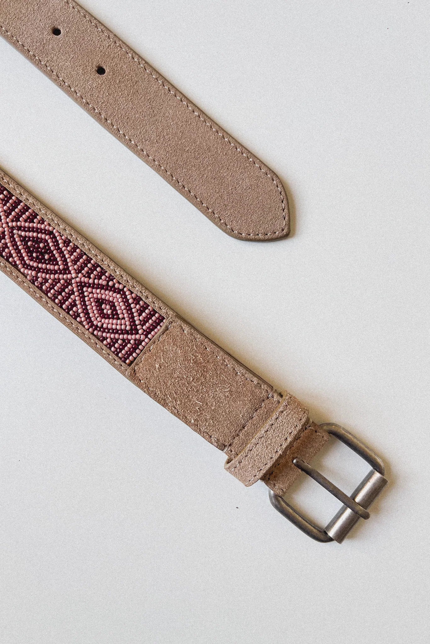 Masai Kilimanjaro leather belt shown flat with square metal buckle and beaded detail.