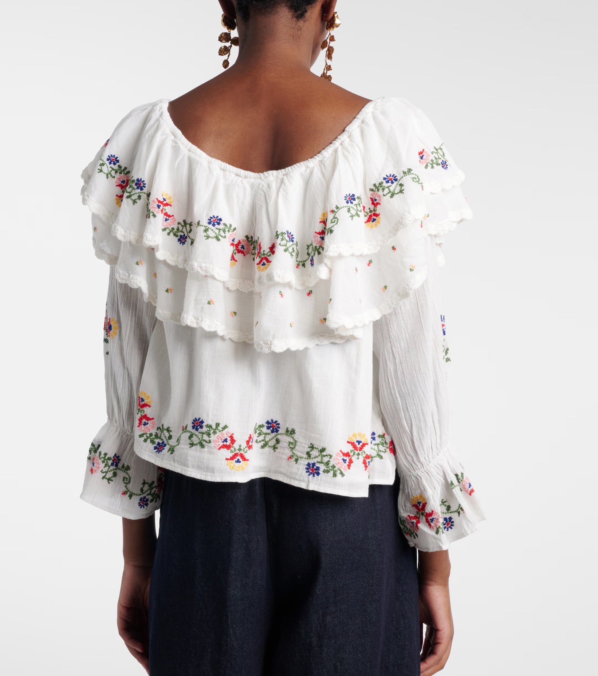 Back view of the Maurine bohemian blouse with flowy silhouette and ruffled neckline