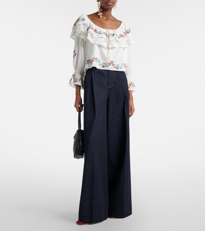 Close-up of the Maurine embroidered top featuring multicolor floral embroidery and gathered ruffle neckline