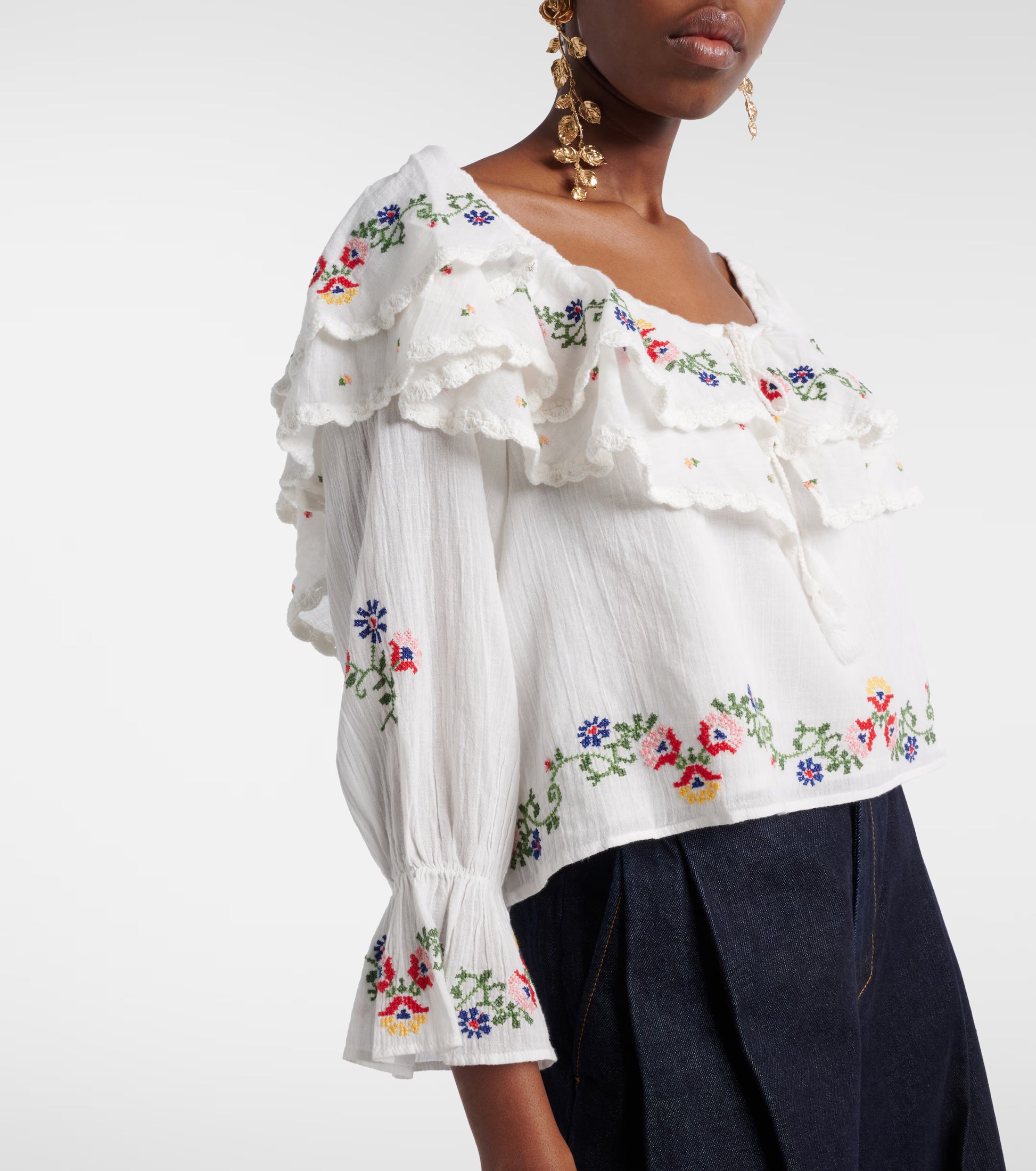 Woman wearing the Maurine off-shoulder bohemian blouse with embroidered detailing and relaxed fit