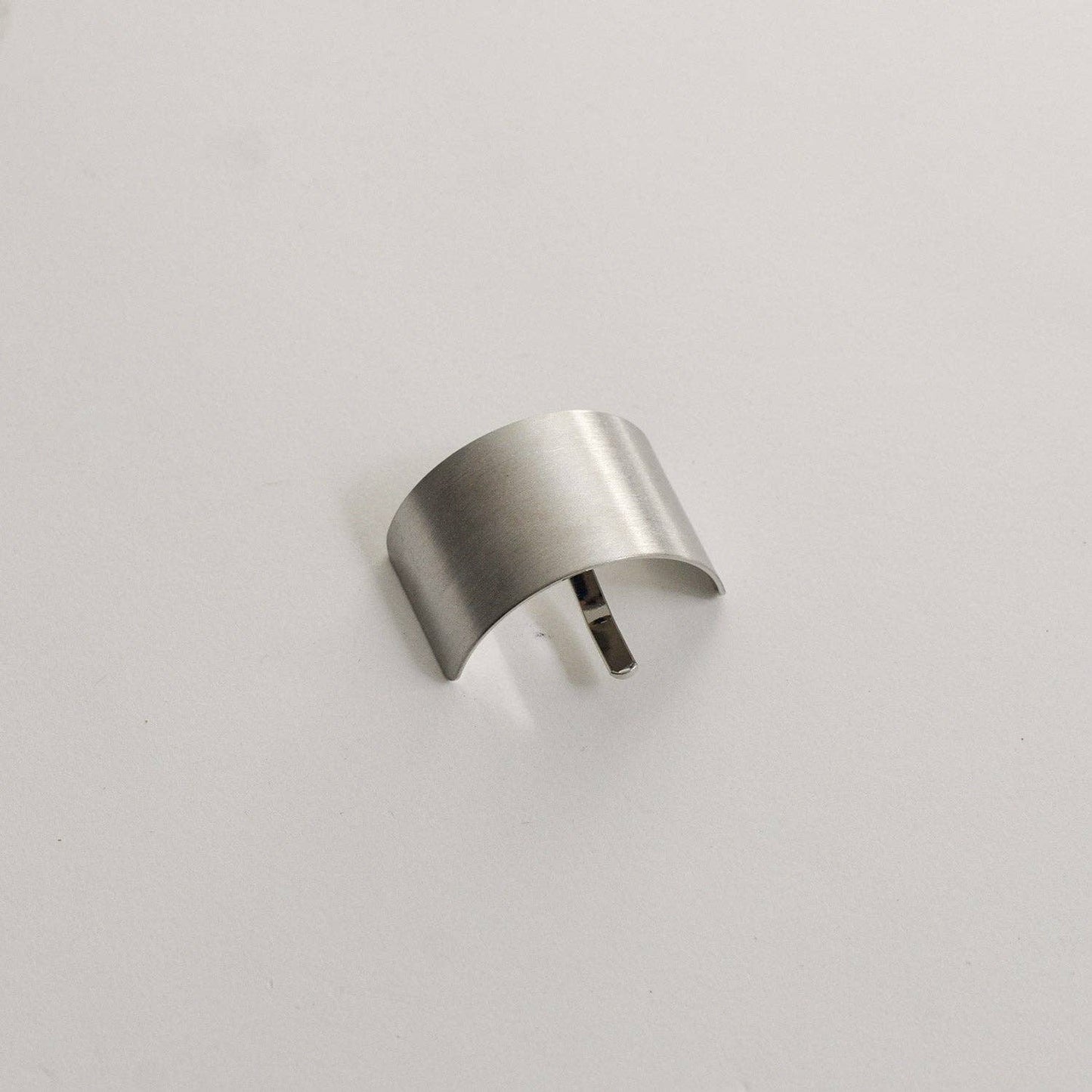 Silver rectangular metal ponytail cuff stick shown from the front on a neutral background.