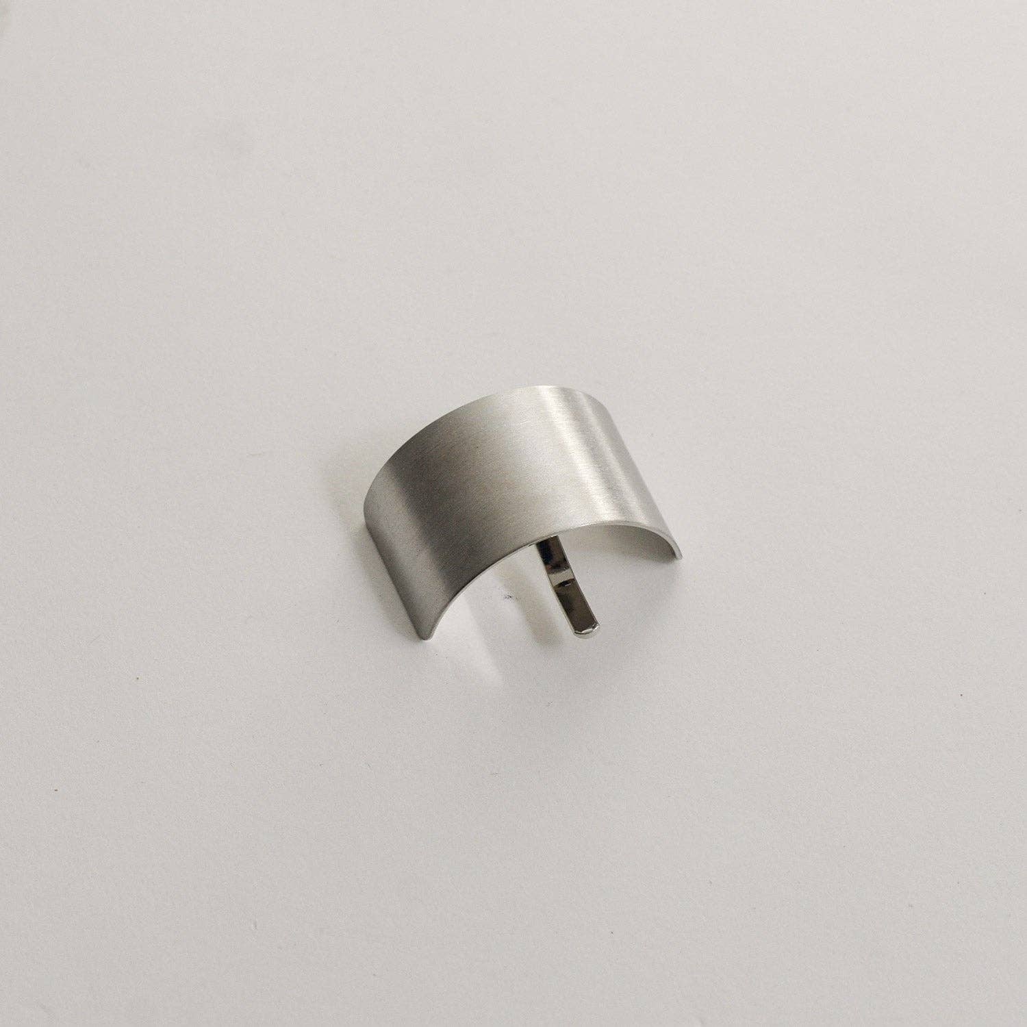 Silver rectangular metal ponytail cuff stick shown from the front on a neutral background.