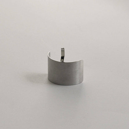 Upright view of the silver rectangular metal ponytail cuff stick highlighting its brushed metal finish.