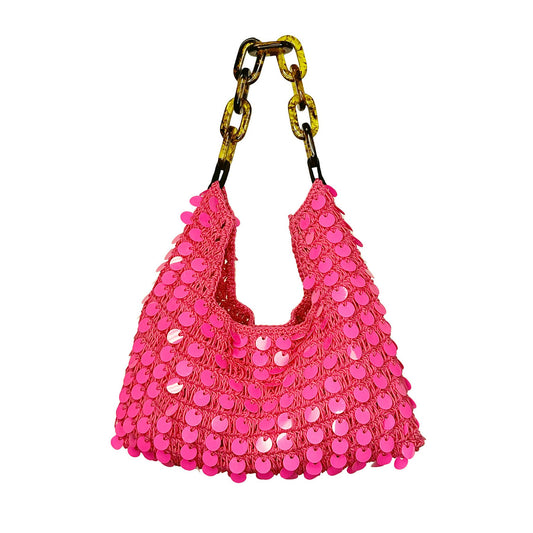 Hand-crocheted cotton purse in bright pink with allover sequin detailing and a tortoiseshell-look acrylic chain handle, shown against a neutral background.