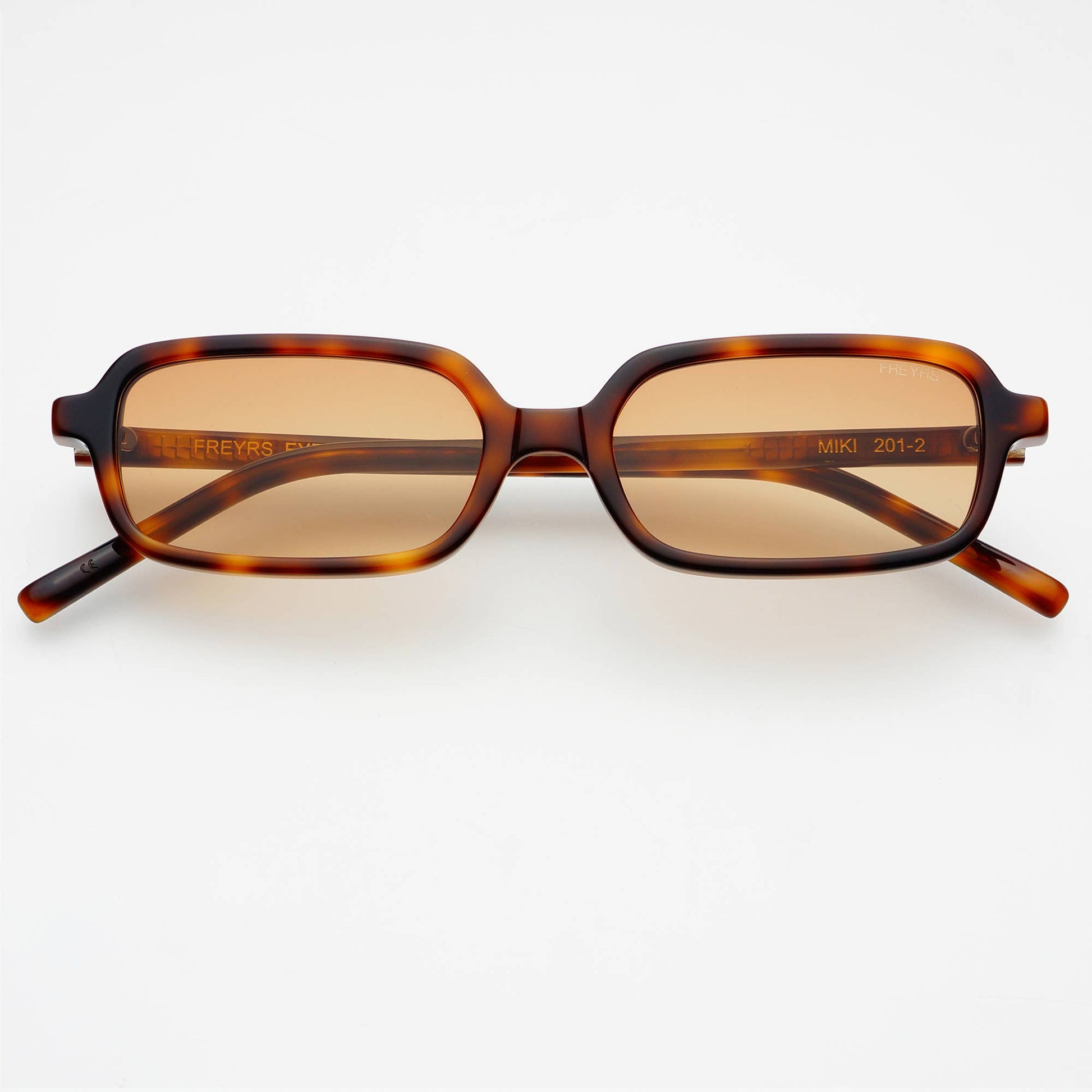 Front view of Miki rectangular unisex sunglasses featuring a tortoise acetate frame and brown UV-protective lenses.