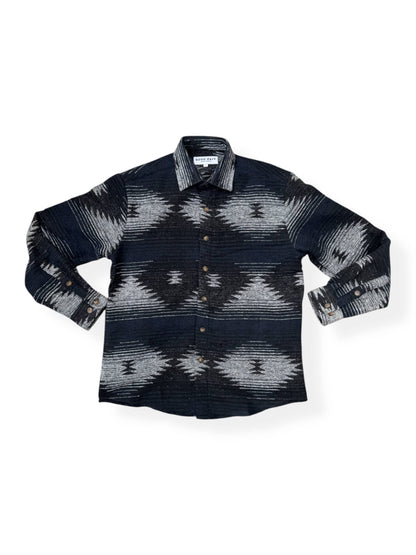 Flat lay front view of the Moab Mid-Weight Button Down showcasing its black and blue Aztec pattern and button-front design.