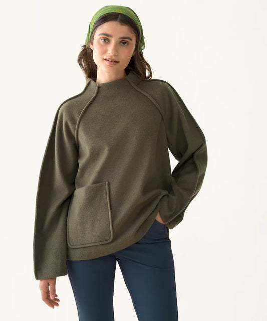 Model wearing the olive Mock Neck Pile Fleece with a relaxed fit, mock neckline, raglan sleeves, and front patch pocket.