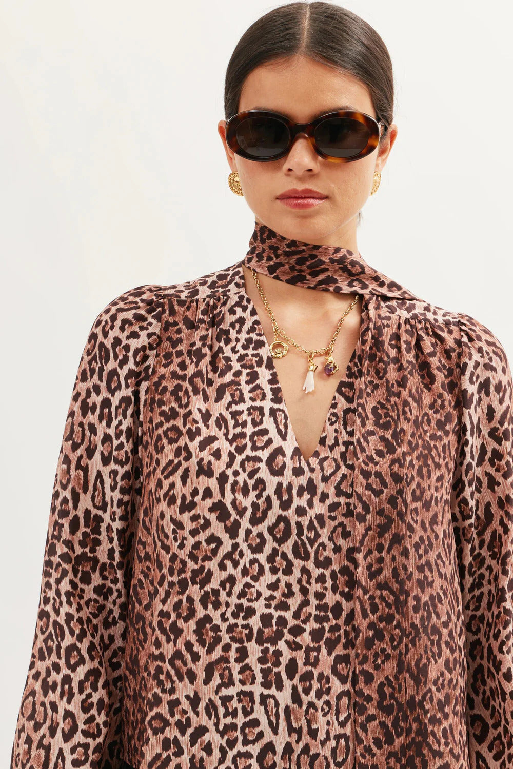 Close-up of the Moss leopard print silk blouse showing the lightweight silk fabric and scarf neckline detail