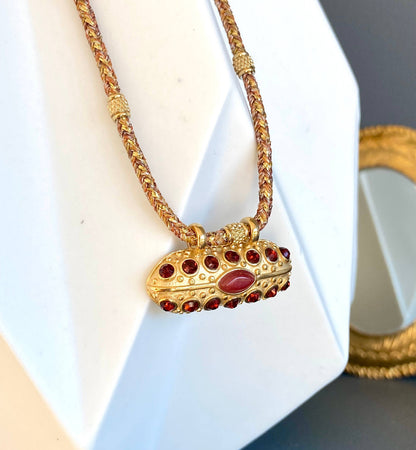 Detailed view of the Mumbai Necklace pendant with carnelian and crystal stones displayed on a white bust.