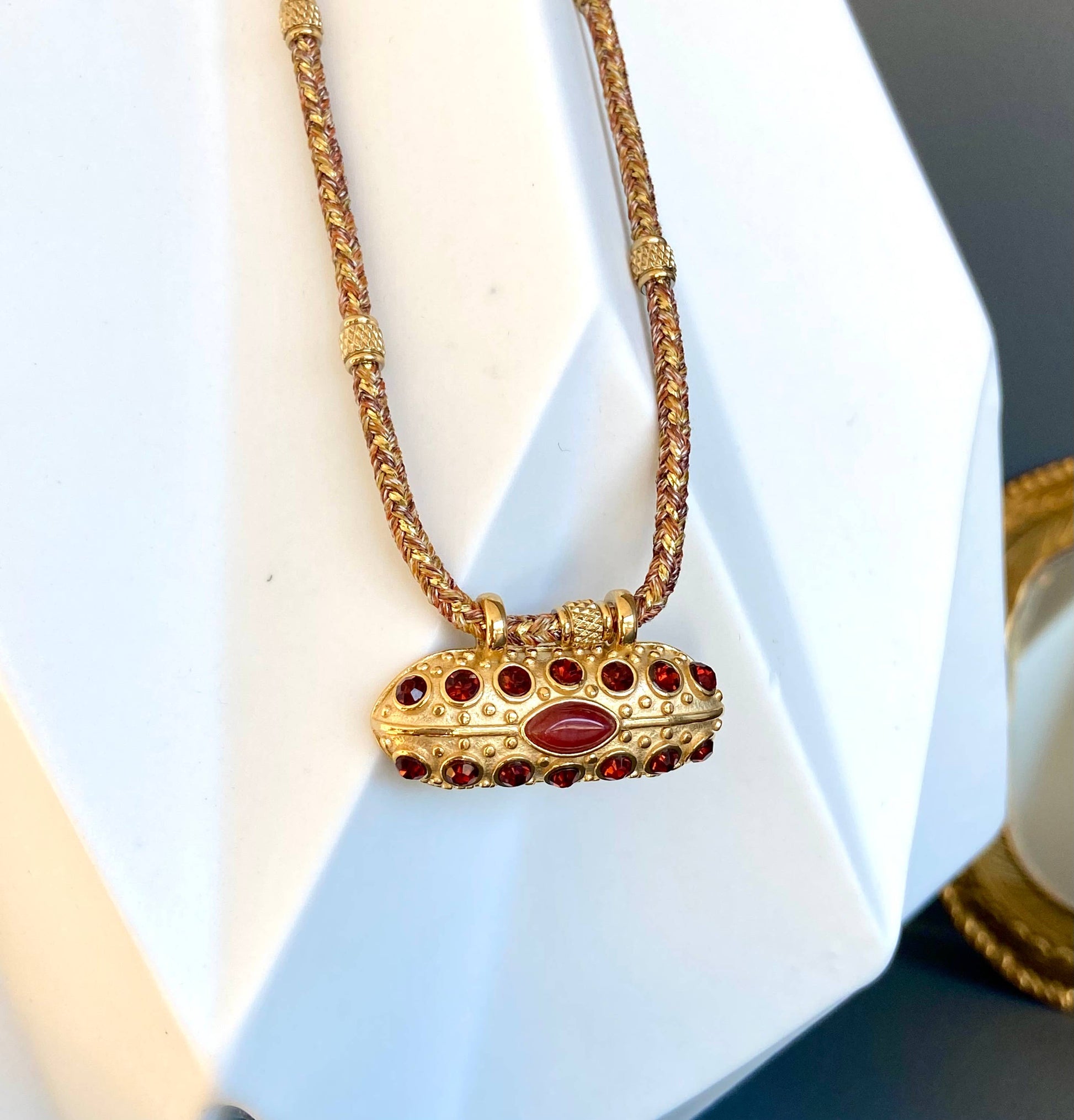Front view of the Mumbai Necklace featuring a gold-plated pendant set with carnelian and crystal stones.