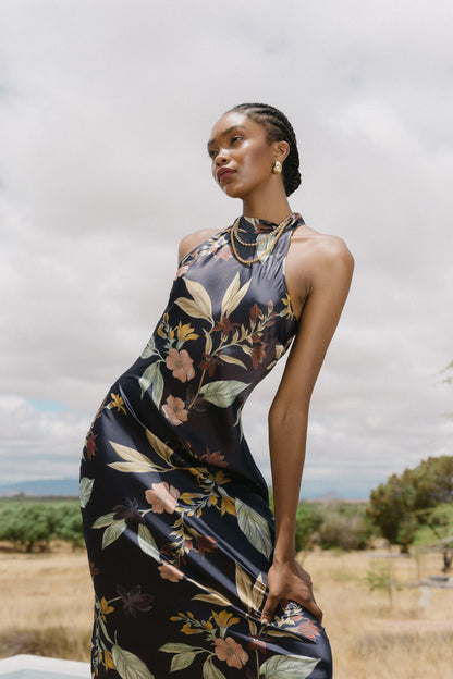 Close-up editorial image of model wearing the Naf Dress in Sundown Floral, highlighting the high neckline and floral print