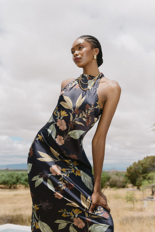 Close-up editorial image of model wearing the Naf Dress in Sundown Floral, highlighting the high neckline and floral print