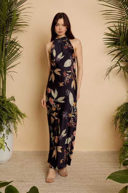Front full-length view of model wearing the Naf Dress in Sundown Floral, a sleeveless floral maxi dress with a high neckline and fluid silhouette
