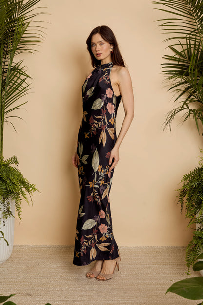 Side view of model wearing the Naf Dress in Sundown Floral, highlighting the body-skimming fit and full-length silhouette
