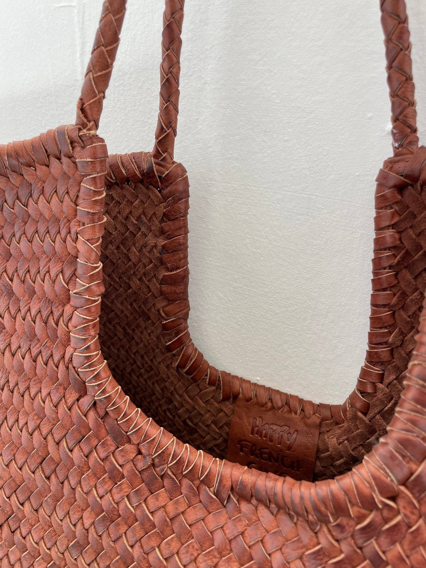 Interior opening detail of the Narmada Brown Bag showing the unlined woven leather construction and artisanal craftsmanship.