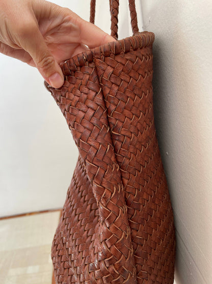 Close-up of the Narmada Brown Bag showcasing the handwoven leather construction, folded side gusset, and artisanal edge detailing.