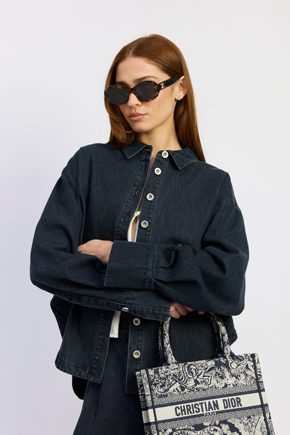 Model styling the Natalia Top in washed vintage indigo denim with matching wide-leg pants and an oversized relaxed fit for an effortless everyday look.
