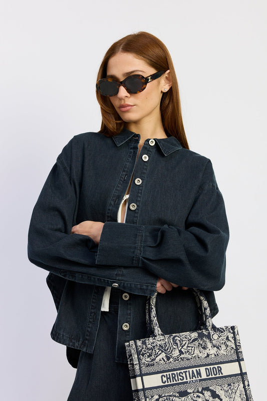 Model styling the Natalia Top in washed vintage indigo denim with matching wide-leg pants and an oversized relaxed fit for an effortless everyday look.