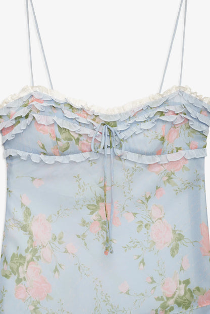 Close-up of the Natalie Maxi Dress featuring layered ruffle detailing, lace trim, floral print, and adjustable front tie at the bodice.