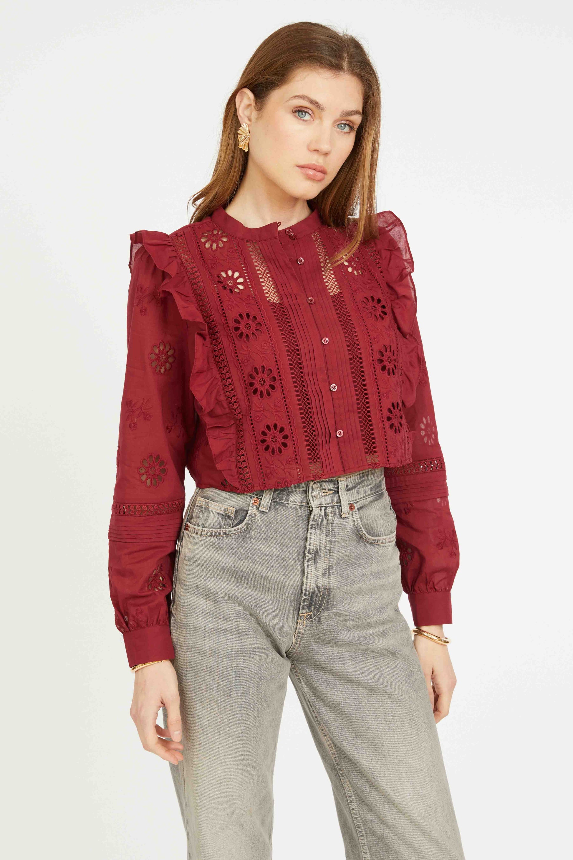 Angled front view of the cabernet Nelly Top featuring floral eyelet details, sheer accents, ruffle trim, and cropped fit.