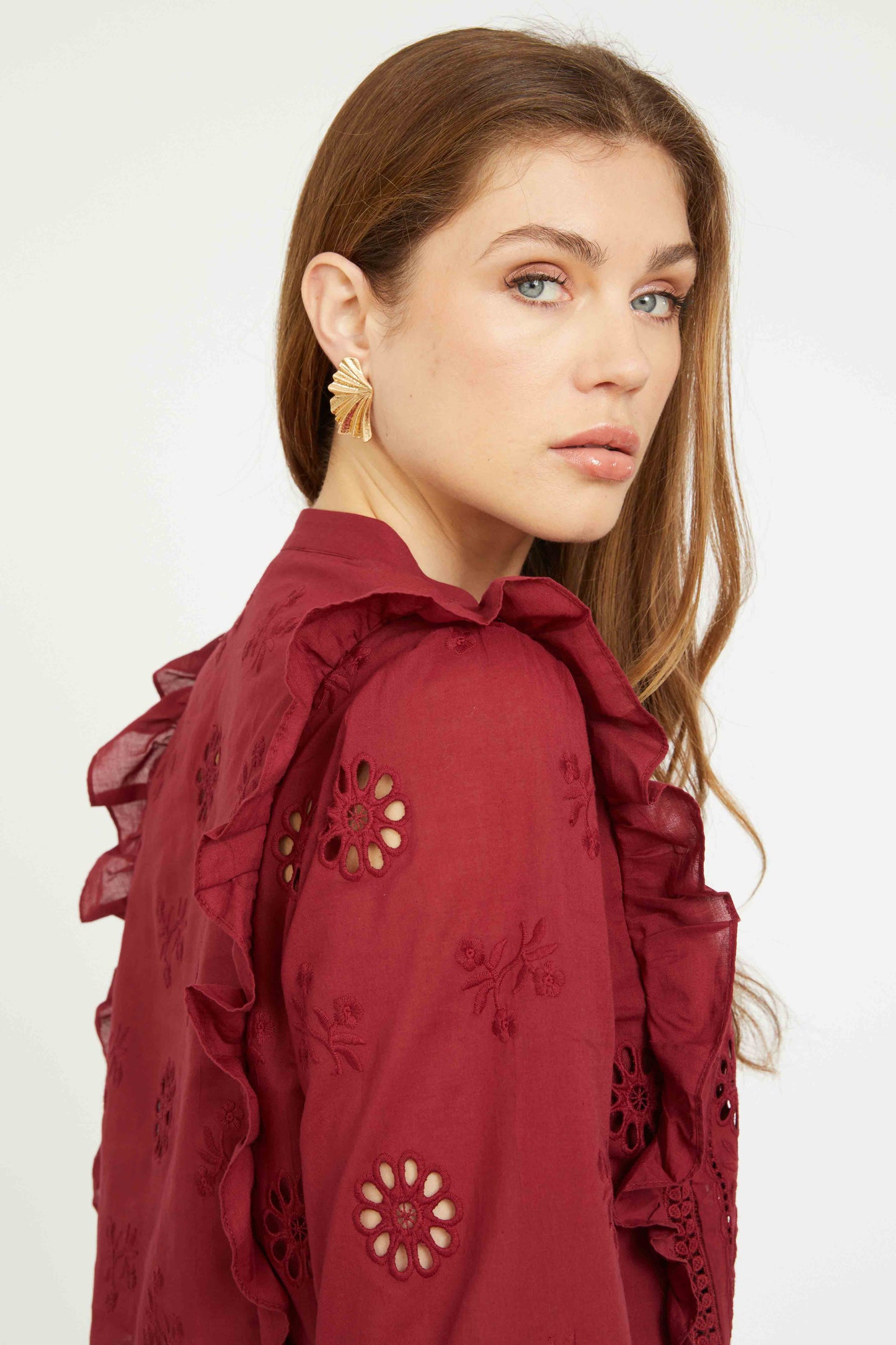 Close-up detail of the Nelly Top in cabernet highlighting floral embroidery, eyelet cut-outs, and soft ruffle detailing on the shoulders.
