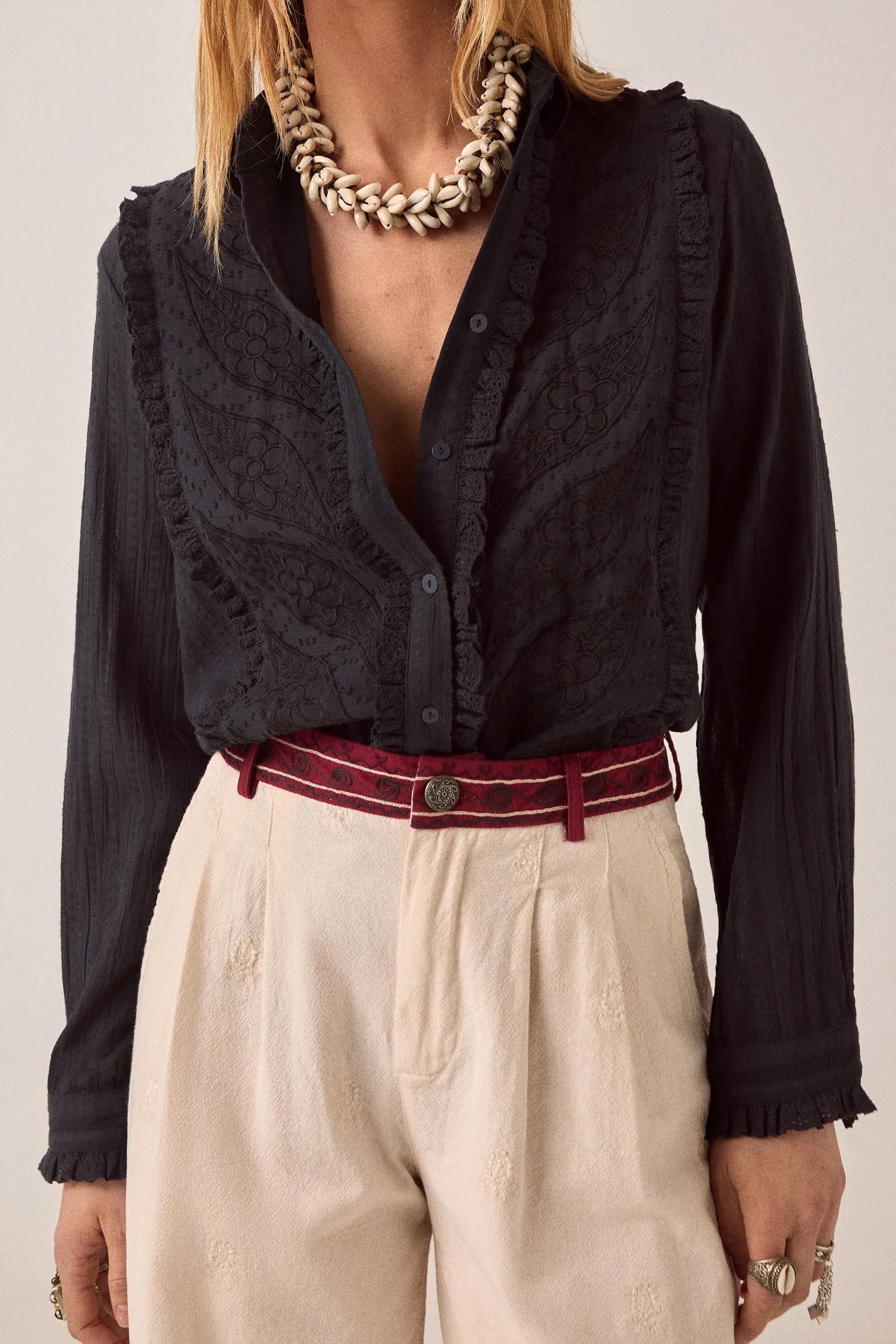 Front view of the Night Fever Javiera Blouse in Onyx featuring tonal floral embroidery, ruffle trim detailing, and a relaxed cotton silhouette.