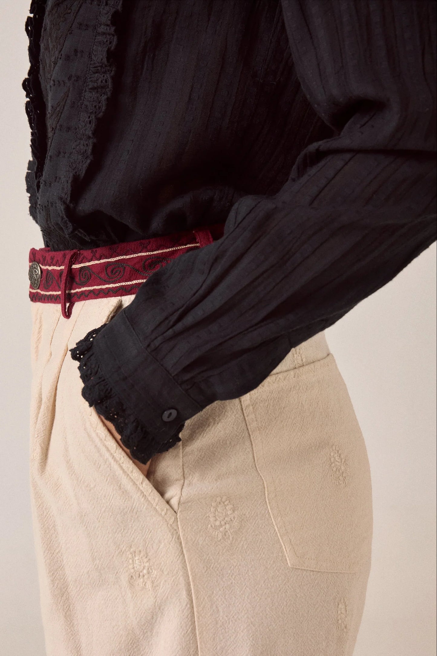 Close-up detail of the Night Fever Javiera Blouse in Onyx highlighting pintuck sleeves, ruffle cuffs, and tonal embroidered cotton fabric.